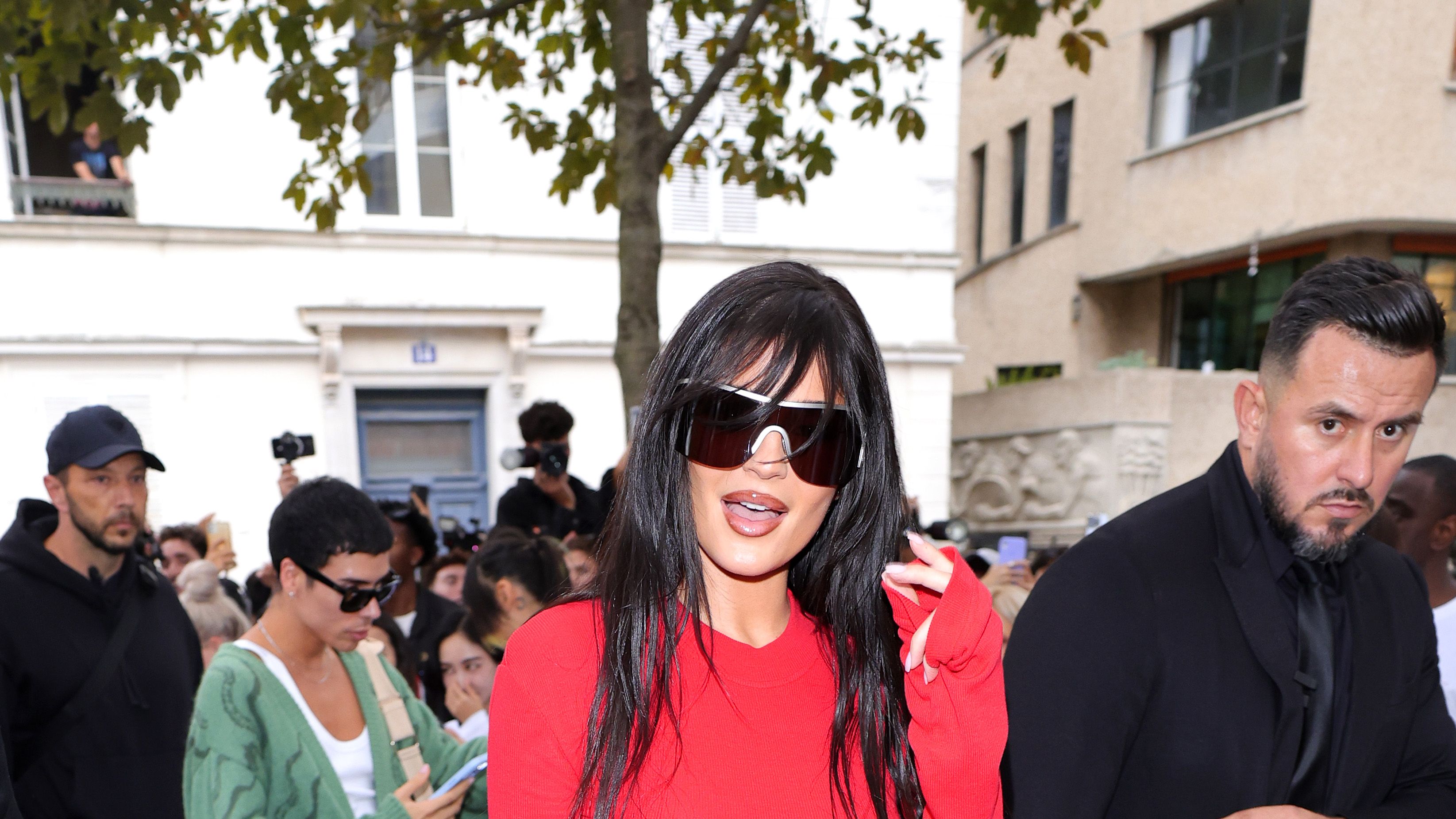 Kylie Jenner Wears Minidress, White Sandals in France With Baby Stormi –  Footwear News