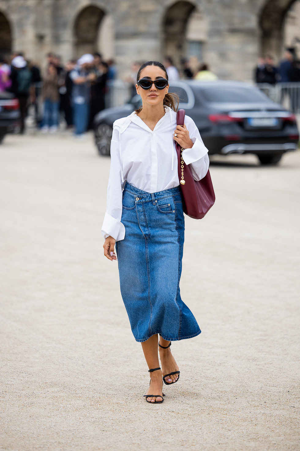 paris, france september 29: tamara kalinic wears denim skirt, white button shirt, burgundy bag outside loewe during the womenswear spring/summer 2024 as part of paris fashion week on september 29, 2023 in paris, france. (photo by christian vierig/getty images)