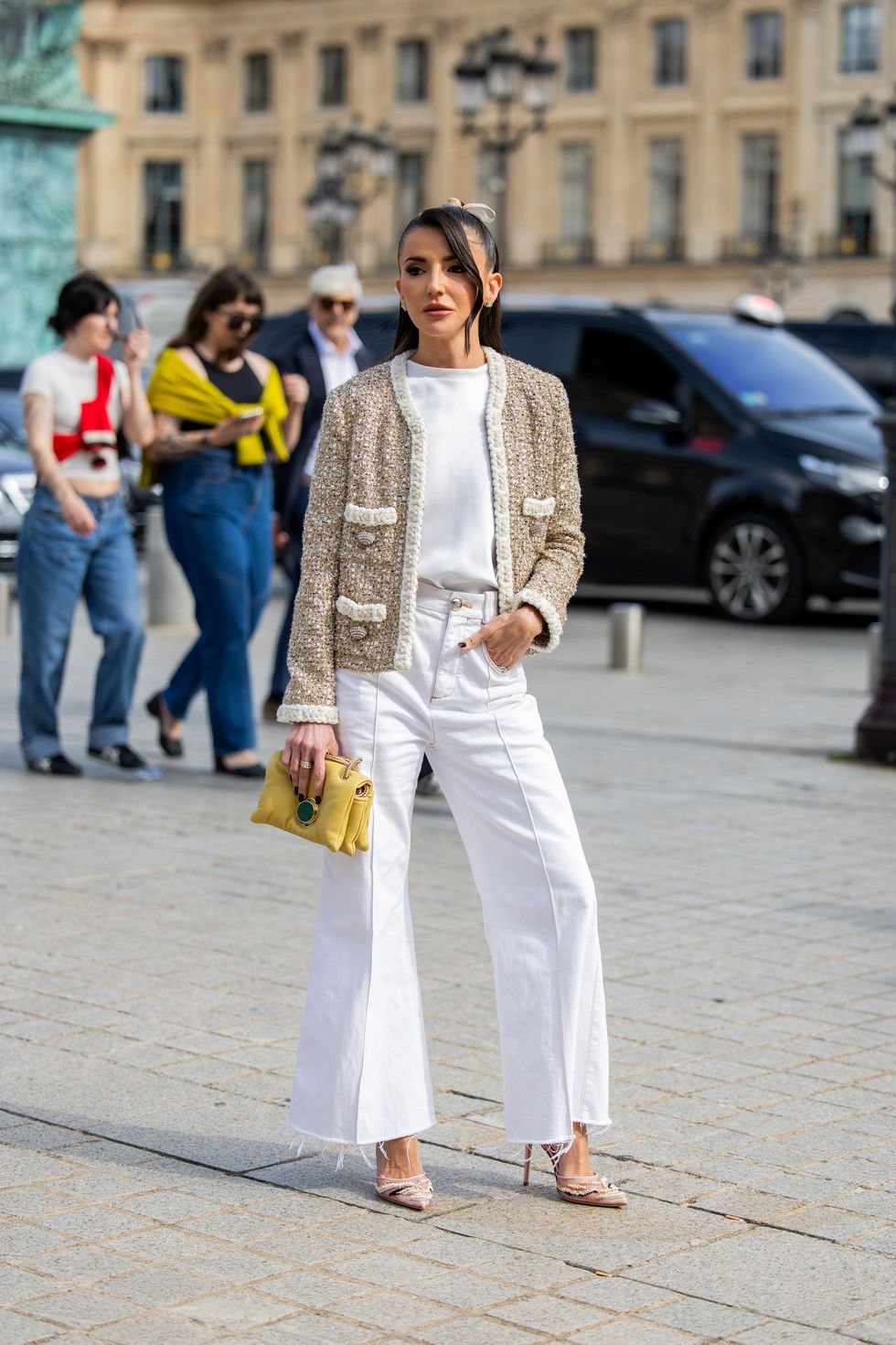 paris, france september 29 alexandra pereira wears cardigan, white flared pants, yellow bag, head band, shirt outside giambattista valli during the womenswear springsummer 2024 as part of paris fashion week on september 29, 2023 in paris, france photo by christian vieriggetty images