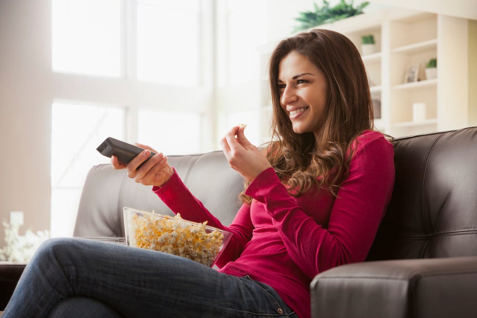 caucasian watching television on sofa