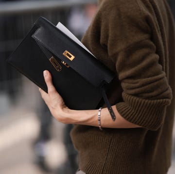 paris, france september 28 guest is seen outside chloe show wearing black sunnies, brown turtle neck sweater, black hermes kelly clutch with golden hardware and light brown suit pants during the womenswear springsummer 2024 as part of paris fashion week on september 28, 2023 in paris, france photo by jeremy moellergetty images