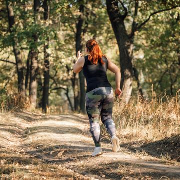 woman running Top on a forest path