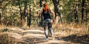 woman running on a forest path