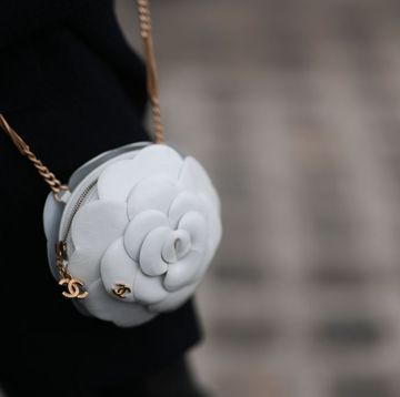 paris, france october 03 guest is seen outside chanel show wearing a white camellia chanel handbag during the womenswear springsummer 2024 as part of paris fashion week on october 03, 2023 in paris, france photo by jeremy moellergetty images