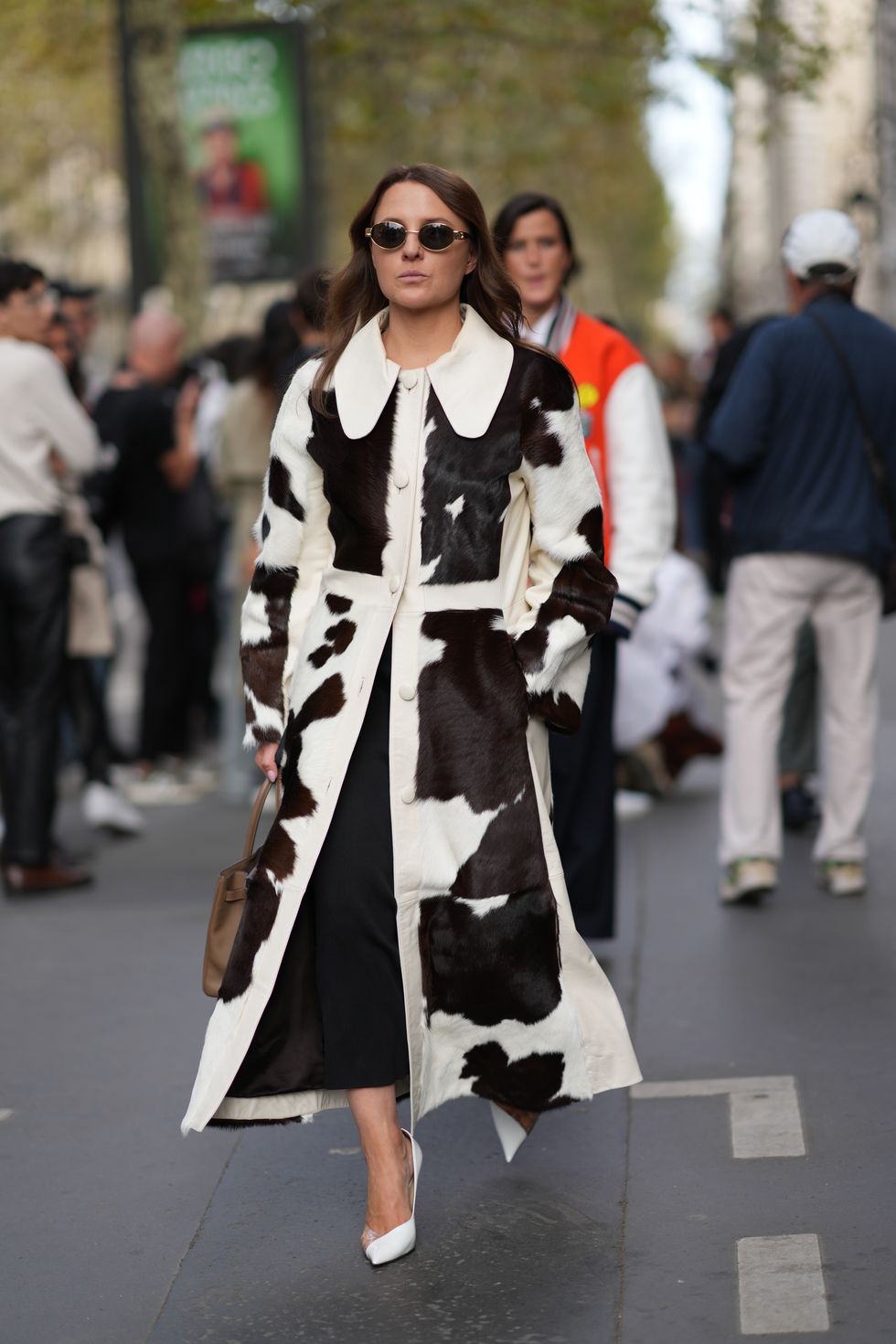 paris, france september 30 a guest wears sunglasses, a black and white cow print coat, white pointed shoes, outside hermes, during the womenswear springsummer 2024 as part of paris fashion week on september 30, 2023 in paris, france photo by edward berthelotgetty images