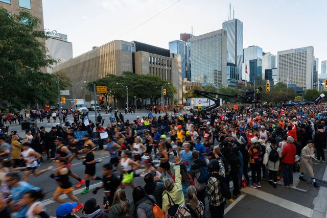 toronto, canada october 15 spectators watch as runners make their way out of the starting gate during the toronto waterfront marathon on october 15, 2023 in toronto, canada photo by cole burstongetty images