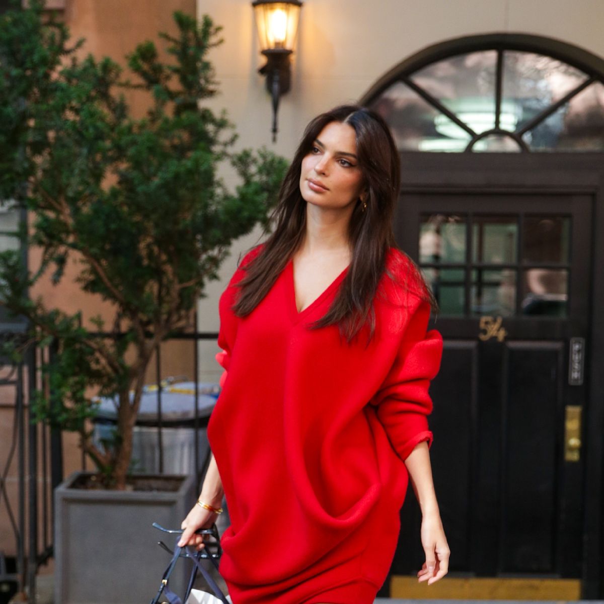 See Emily Ratajkowski Elevate a Red Sweater Dress with Snakeskin Boots
