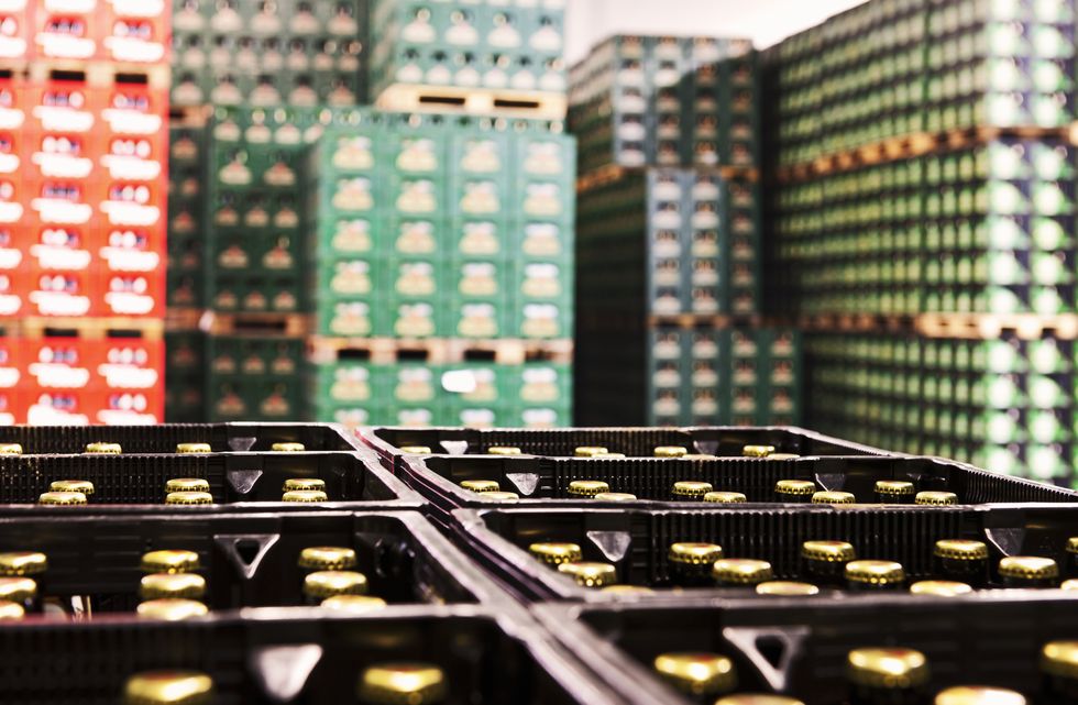 a warehouse filled with beer  focus on bottles in foreground