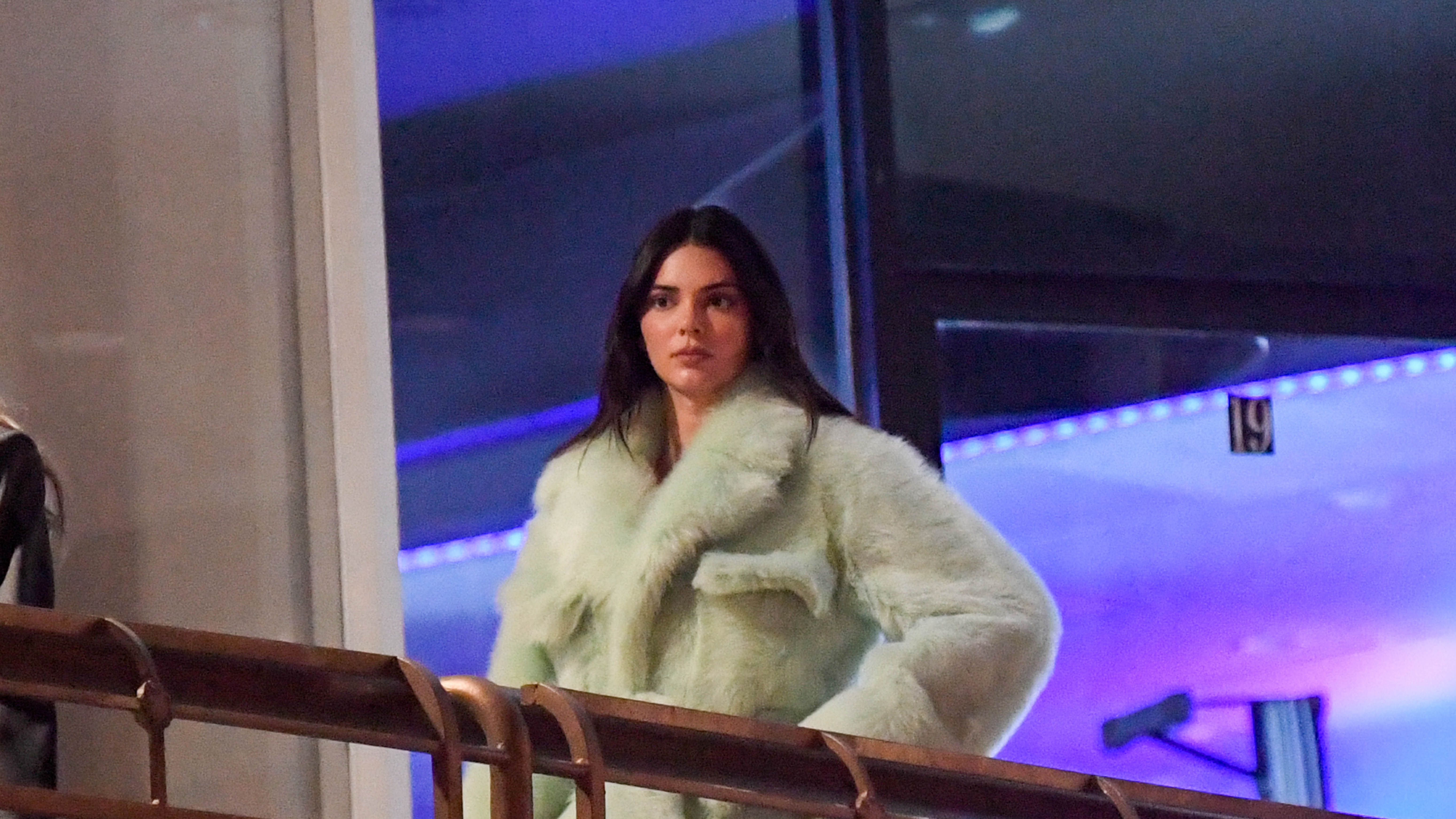 Kendall Jenner clutches large pillow as she and Kylie arrive at