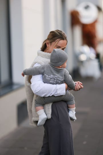 cologne, germany october 21 anna lena schulz seen wearing famvibes white cotton longsleeve, famvibes white cream fluffy teddy gilet, nadine tosun label grey wide leg suit pants baby is completely dressed in famvibes, on october 21, 2023 in cologne, germany photo by jeremy moellergetty images