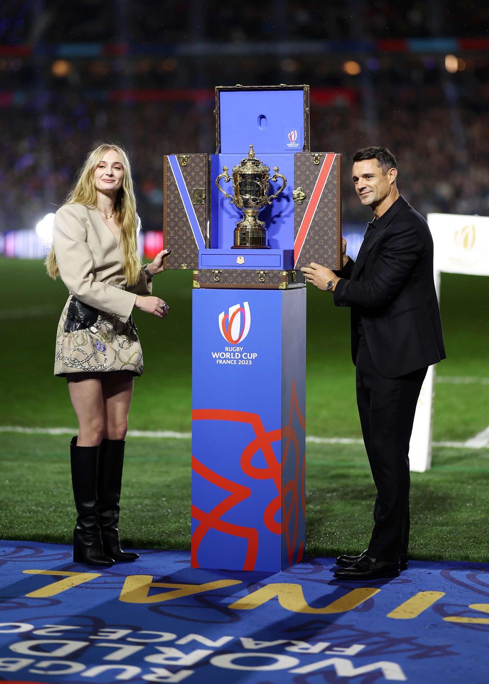 a man and woman holding a trophy