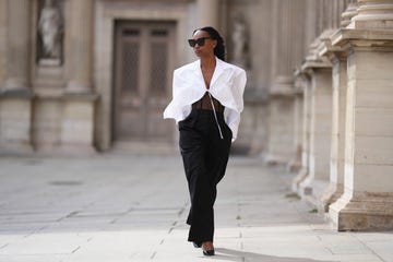 paris, france july 17 emilie joseph wears sunglasses, a white oversized opened shirt, black high waist wide leg suit pants, black high heels pointed shiny shoes, during a street style fashion photo session, on july 17, 2023 in paris, france photo by edward berthelotgetty images