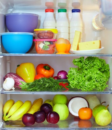 refrigerator full of healthy food. fruits, vegetables and dairy products