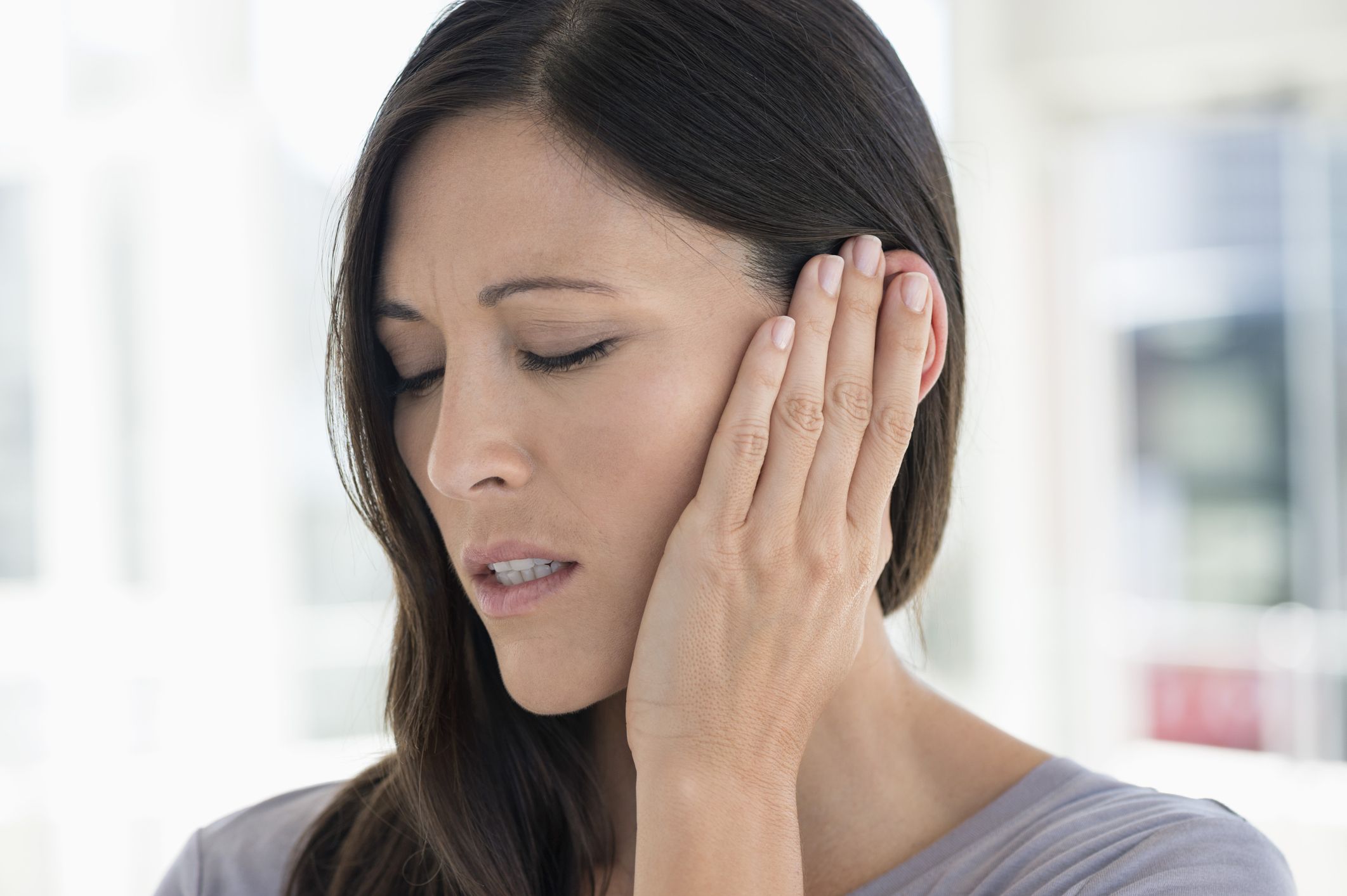 Woman suffering from an ear ache