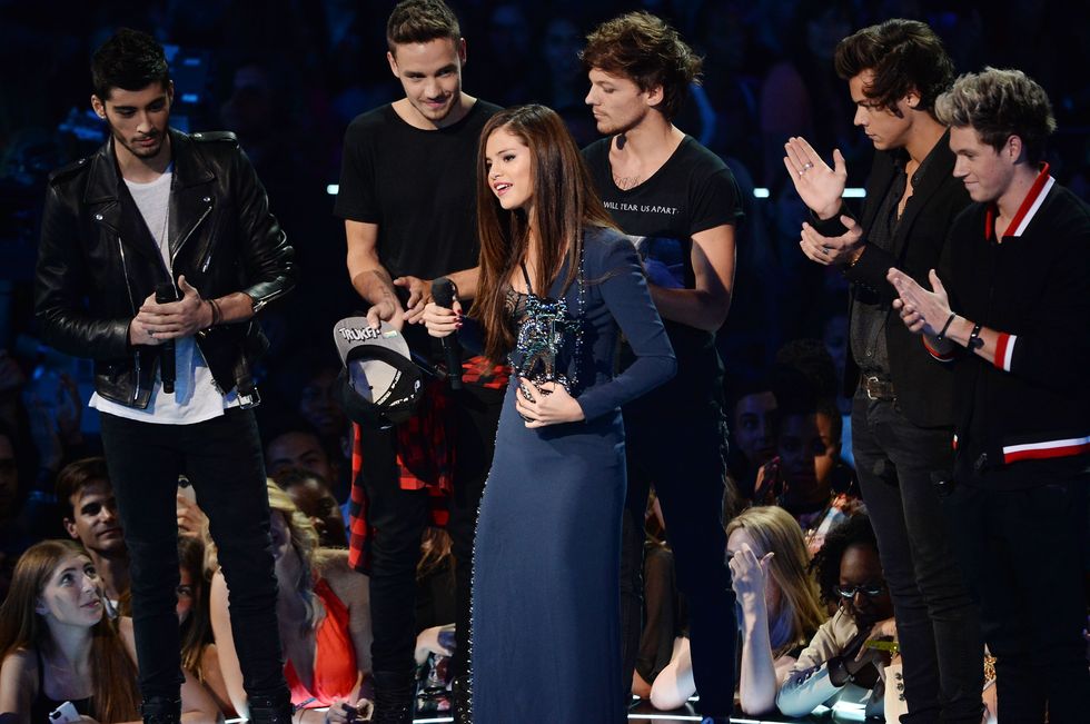 new york, ny   august 25  one direction present the best pop video award to selena gomez detail atelier versace dress for come and get it  during the 2013 mtv video music awards at the barclays center on august 25, 2013 in the brooklyn borough of new york city  photo by theo wargowireimage