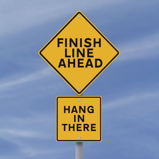 a road sign announcing the finish line just ahead