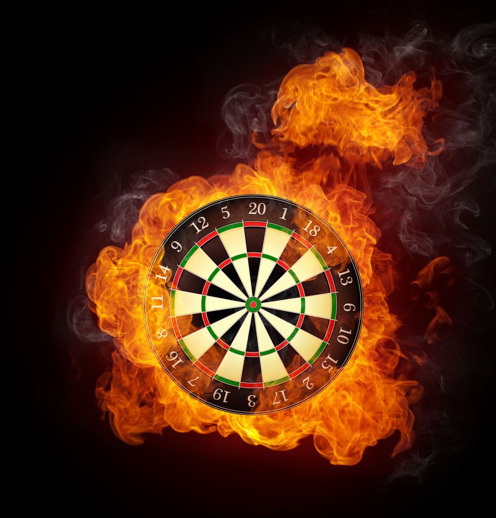 darts board in fire isolated on black background