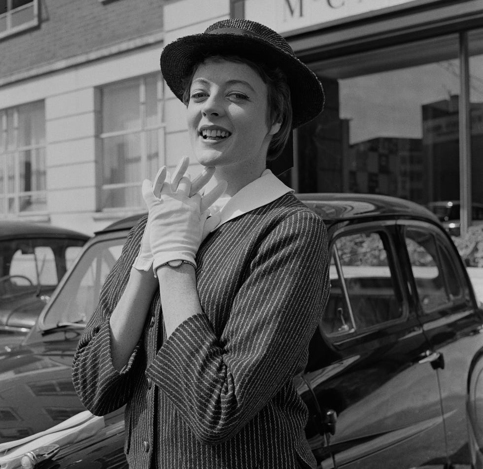 actress maggie smith posing with her hands clasped below her chin, august 27th 1957