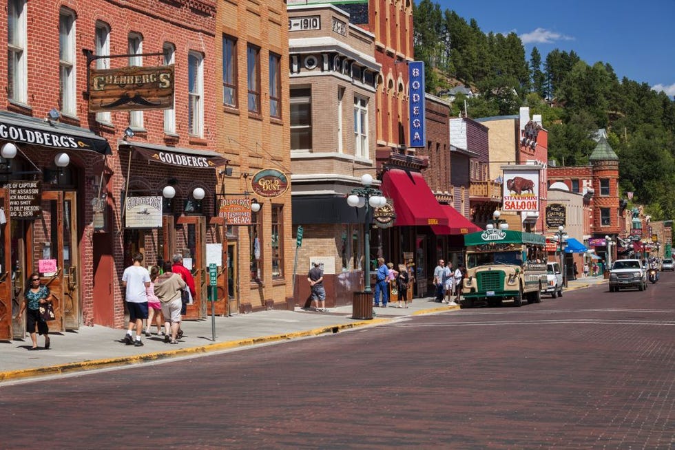 tourist explore main street in historic deadwood, south dakota