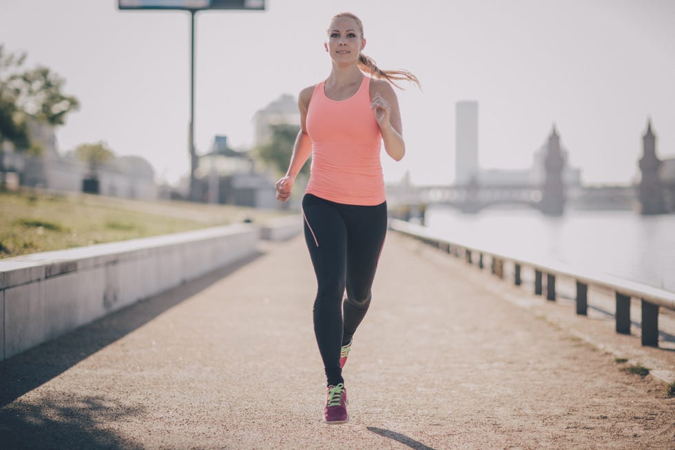 blondhaired woman running in urban scene