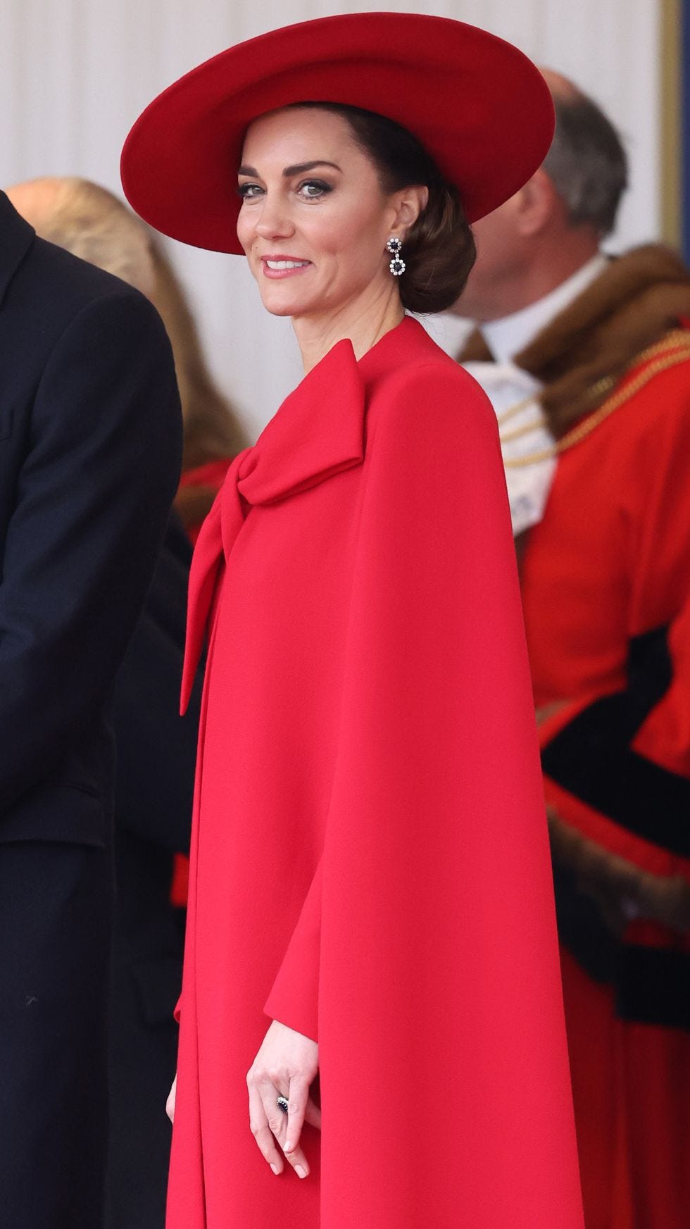 Kate Middleton Revives Royal Glamour in a Candy-Apple Red Cape Dress