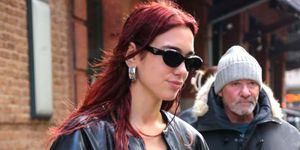 a woman with red hair and sunglasses