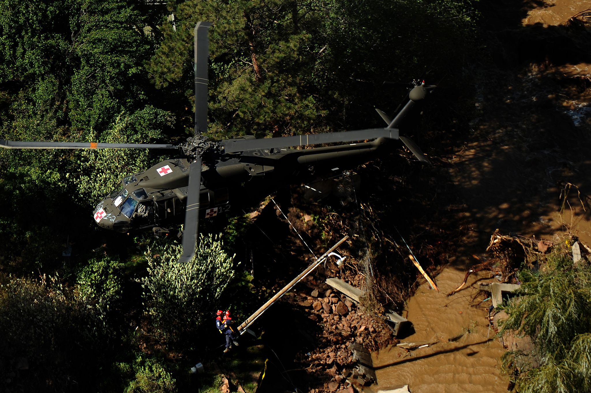 fema personal are hoisted into a uh 60 black hawk by us army soldiers during flooding in boulder colorado