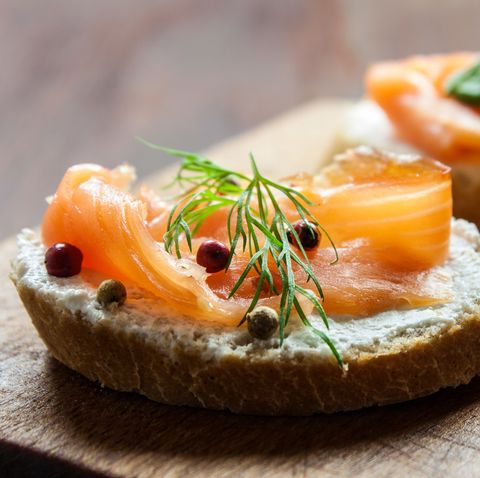 Smoked salmon canapes on a brown wooden plate