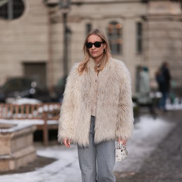 berlin, germany november 30 marlies pia pfeifhofer seen wearing ray ban wayfarer black sunglasses, silver earrings, dondup cream white fluffy fake fur jacket, massimo dutti light frey flared jeans pants, dior white leather mini lady dior bag with embroidered butterflies pattern and jimmy choo black leather boots, on november 30, 2023 in berlin, germany photo by jeremy moellergetty images