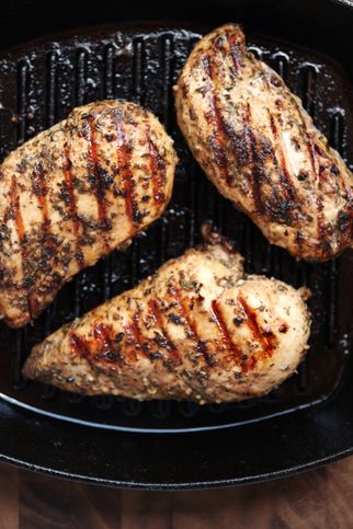 healthy eating  grilled skinless, boneless chicken breasts in a cast iron grilling pan