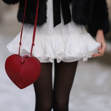 berlin, germany december 04 celine bethmann seen wearing mango white ruffled short dress, pepe jeans black fake fur jacket with ribbon details, calzedonia black tights, alaia red leather hearth shaped bag, on december 04, 2023 in berlin, germany photo by jeremy moellergetty images