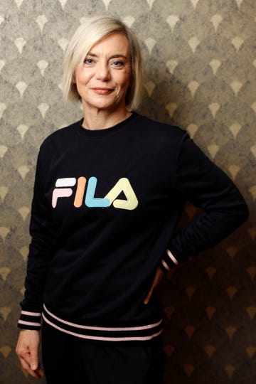 a woman wearing a fila jumper