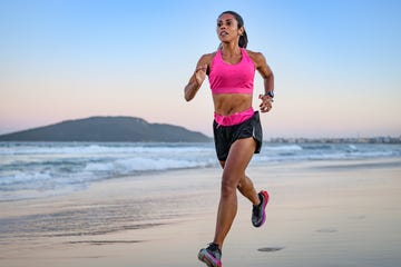 woman running along a sandy beach
