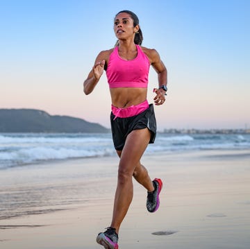 woman running along a sandy beach woman running along a sandy beach
