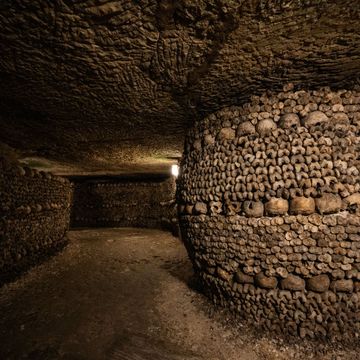 topshot this photograph taken on december 12, 2023, shows human skulls and bones aligned against a wall of paris catacombs, the citys former quarries where the remains of some six million people where transferred from saturated parisian cemeteries between the end of the 18th century until 1861 photo by julien de rosa afp photo by julien de rosaafp via getty images