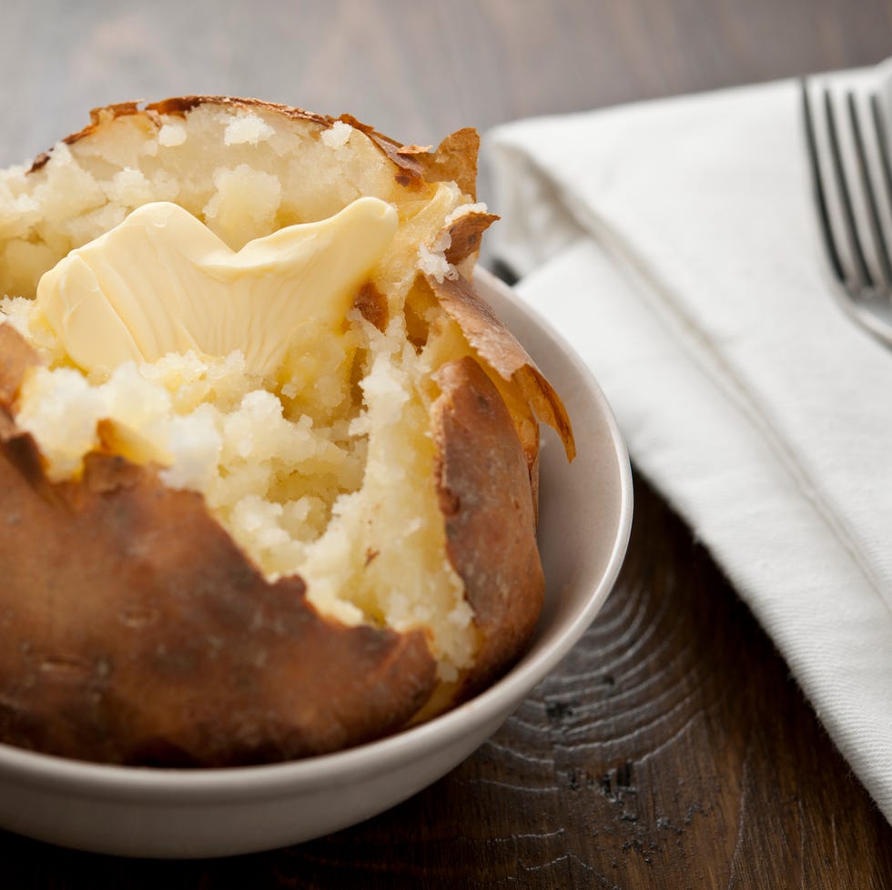 Baked potato with melting butter baked potato with melting butter, horizontal