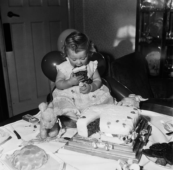 vintage birthday photos margaret harding eating a slice of birthday cake during her first birthday party in north london, december 1948. she is looking at the birthday candle holder, seen in her left hand. (photo by chris ware/keystone features/hulton archive/getty images)