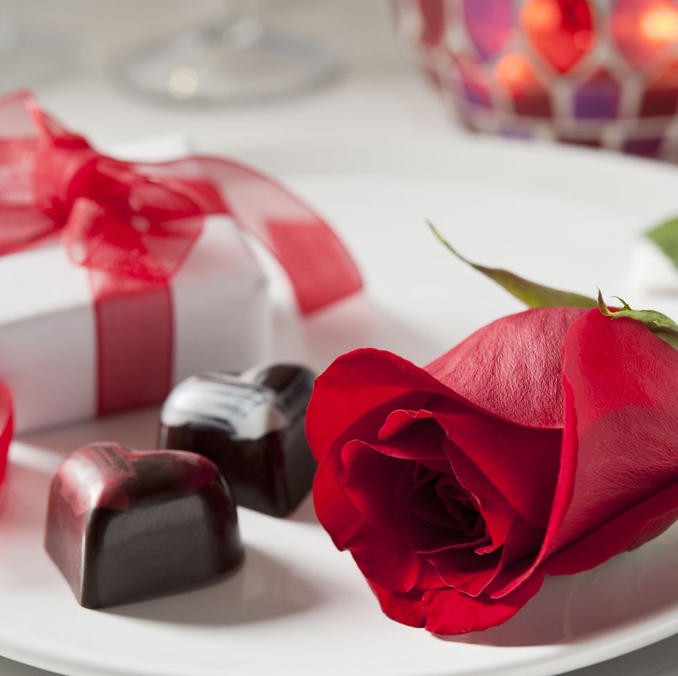 several more in this series perfect red rose, gift box, and heart shaped chocolates in a table setting very shallow dof