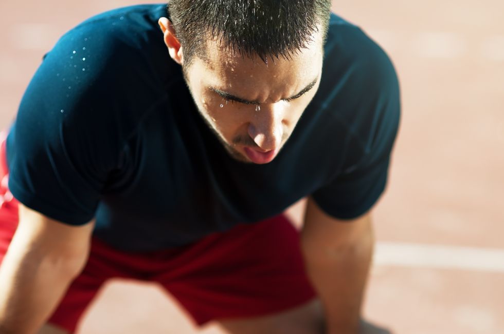 close up of a sporty man taking a breath after running