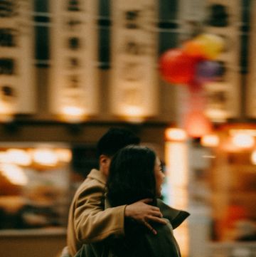 rear view of couple in blurred motion at night in tokyo backstreet alley in winter