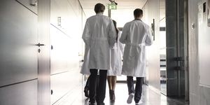 team of doctors walking in hospital hallway