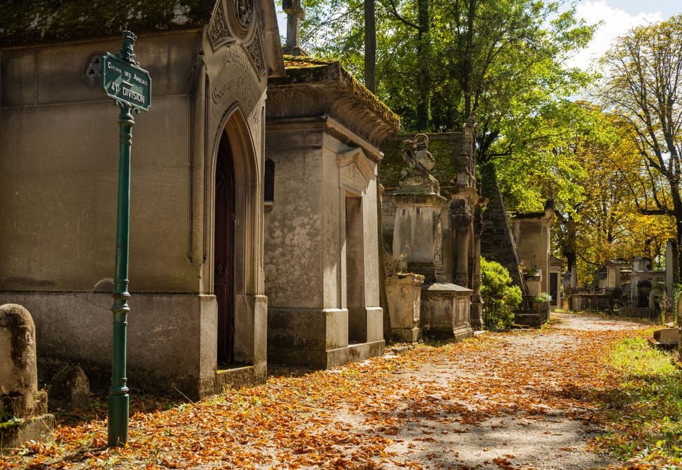 a tree-lined path with extensive 19th century Catholic family graves at the famous Pere Lachaise Cemetery in Paris, France photo by andy solomanucguniversal images group via getty images