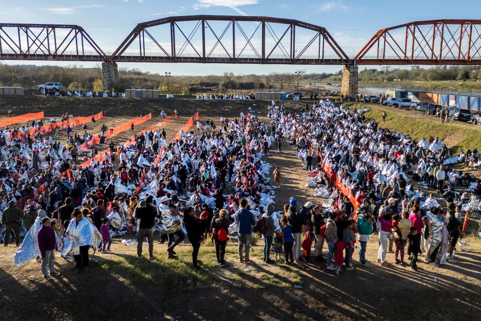 eagle pass, texas december 19 in an aerial view, thousands of immigrants, most wearing thermal blankets, await processing at a us border patrol transit center on december 19, 2023 in eagle pass, texas major surges of migrants illegally crossing the rio grande have overwhelmed us border authorities in recent weeks photo by john mooregetty images