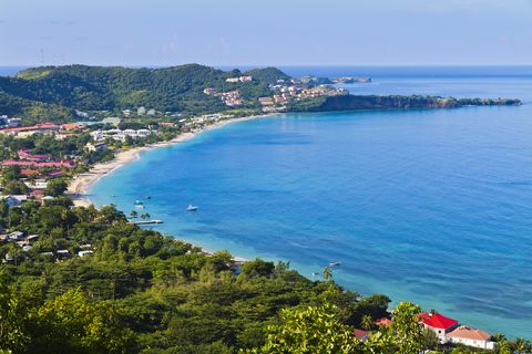 grand anse bay seen from the hill top of jean anglais grand anse beach is a two miles beach of white sand located on the western leeward side of grenada sheltered from high waves, strong currents, and winds, it is become the favorite beach for tourists and locals grenada wi