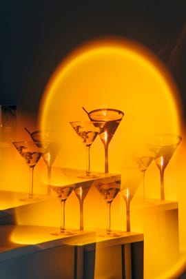 kaleidoscope image of martini cocktail in orange neon background