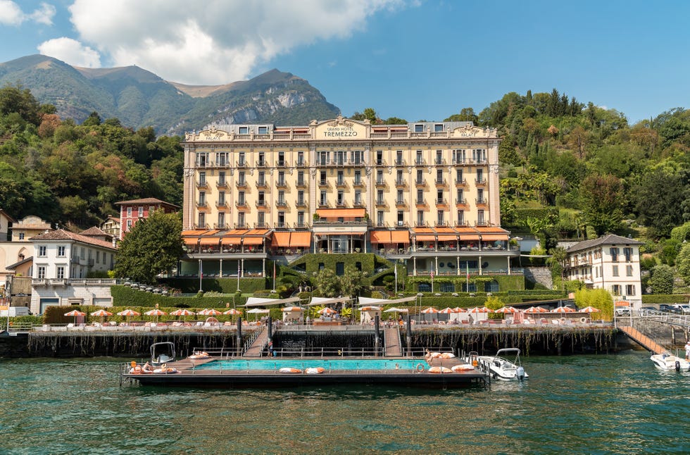 tremezzina, lombardy, italy september 5, 2022: view of the luxury grand hotel tremezzo with swimming pool on the shore of lake como.