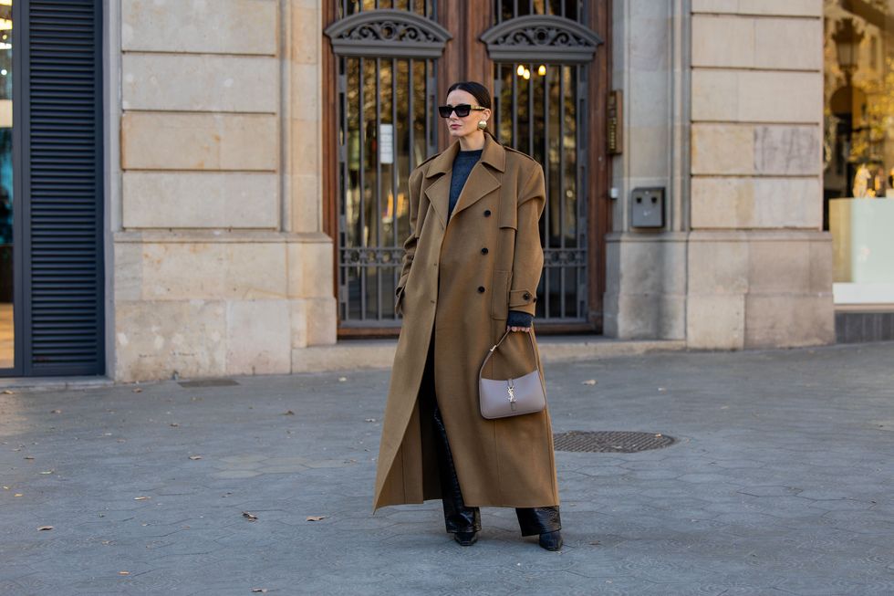 barcelona, spain january 09 zina charkoplia wears black sweater, pants, brown oversized double breasted coat by frankie shop, pointed boots by proenza schouler, grey ysl bag, gigi studios sunnies, earrings on january 09, 2024 in barcelona, spain photo by christian vieriggetty images