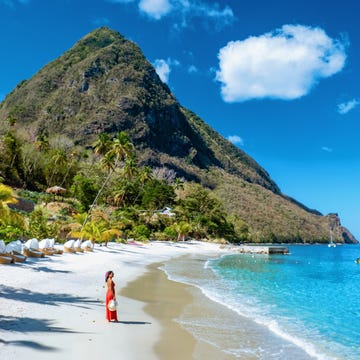 St Lucia Caribbean, woman on vacation at the tropical Island of Saint Lucia st lucia caribbean, woman on vacation at the tropical island of saint lucia caribbean ocean, an asian woman in red dress walking on the beach