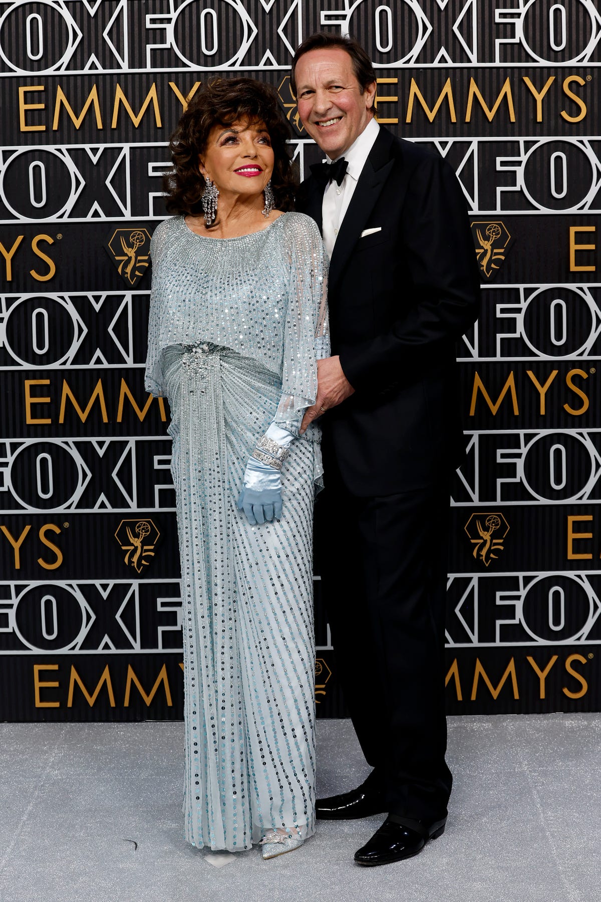 Dame Joan Collins dazzles in flowing sequin gown at the Emmys