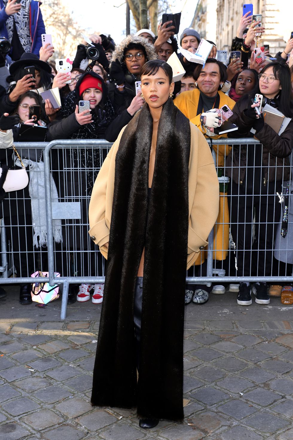 Taylor Russell Goes Pantsless in a Camel Coat and Fur Scarf at Paris  Fashion Week
